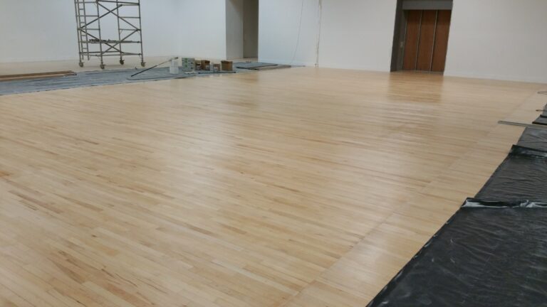 Community Hall Floor Sanding on a solid hardwood strip hall floor, showing a freshly sanded light timber surface ready for sealing in a large multi-purpose space.