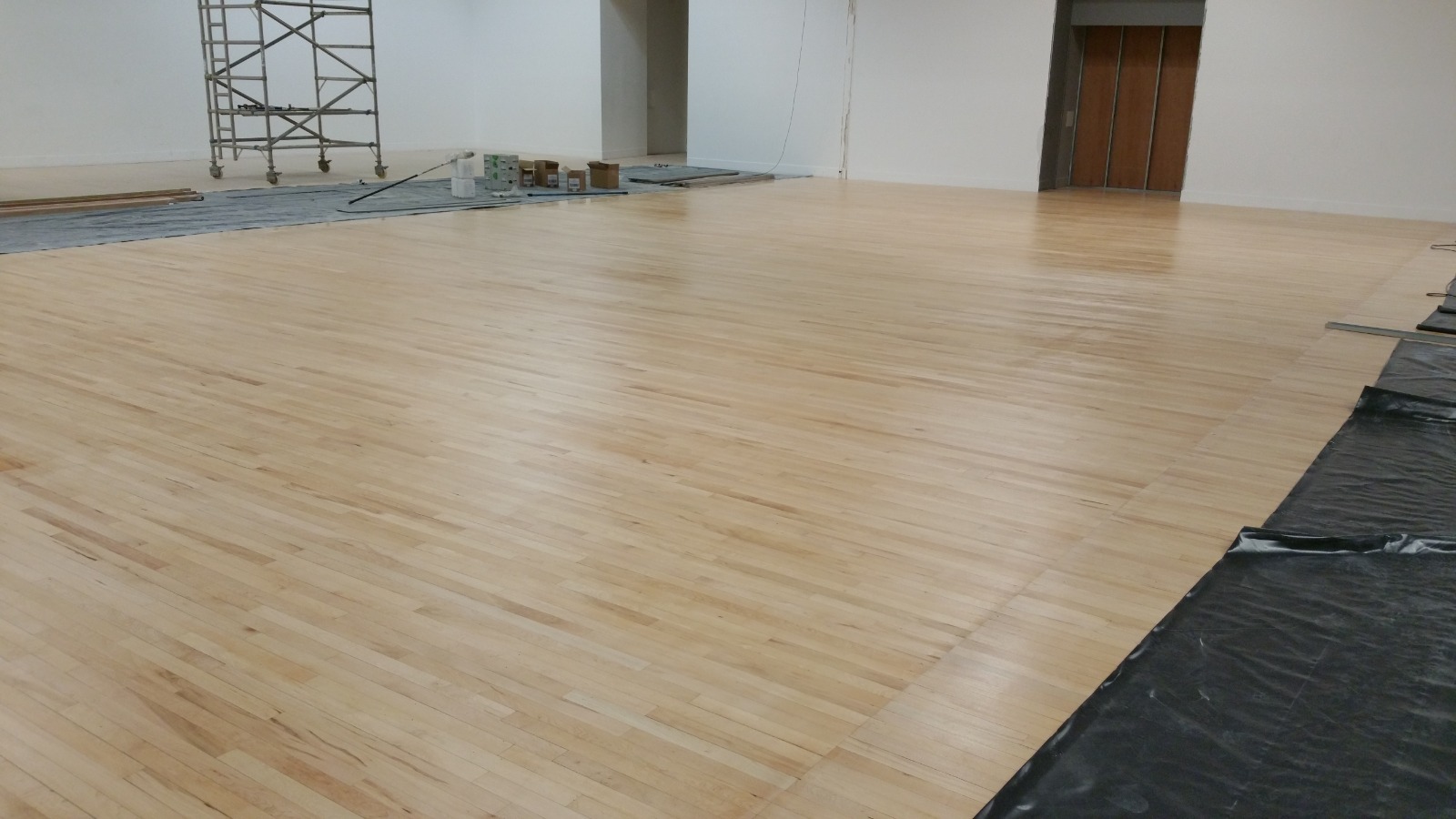 Community Hall Floor Sanding on a solid hardwood strip hall floor, showing a freshly sanded light timber surface ready for sealing in a large multi-purpose space.