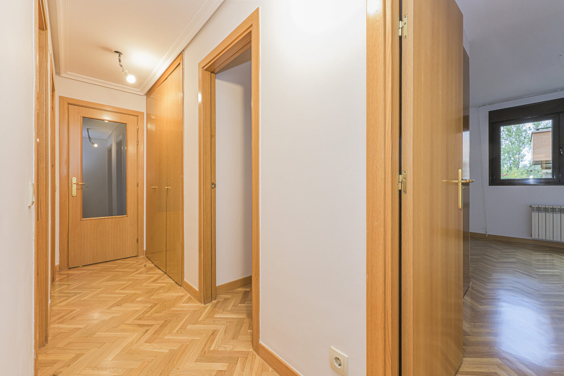 Light engineered oak herringbone parquet hallway with satin finish and clean edging—Flawless Herringbone Hallways showcasing seamless flow.