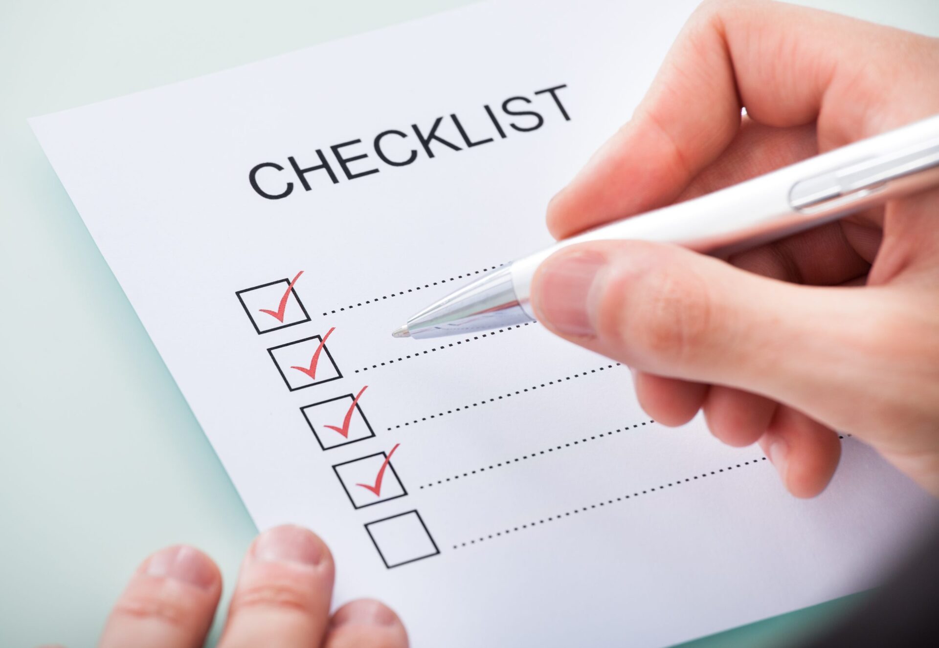Detailed checklist being ticked off by a Floor Fitter planning an oak wood floor installation on smooth engineered oak boards.