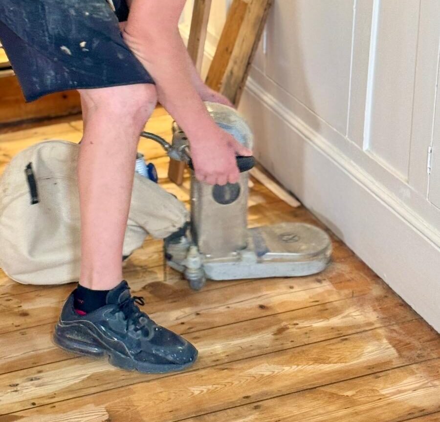 Floor Restoration in action—Mr Sander® technician edge-sanding solid oak floorboards for a flawless finish.