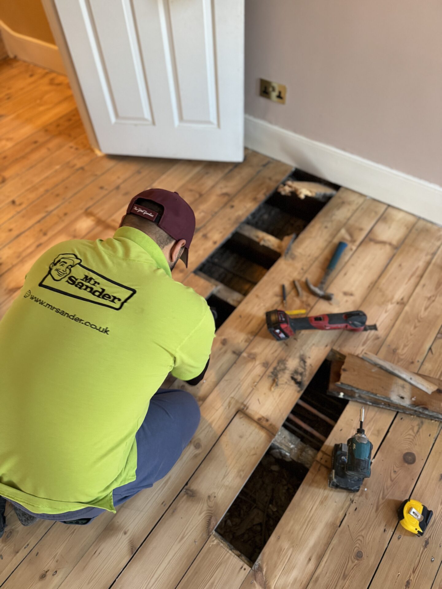 Floor Restoration specialist from Mr Sander® repairing Victorian pine floorboards, removing damaged boards for a seamless restoration.