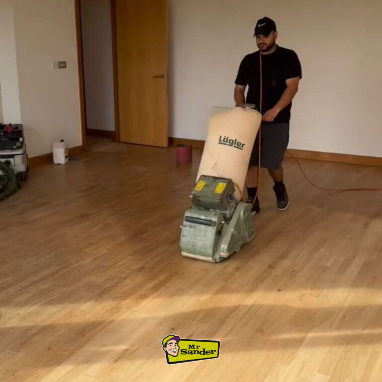 Floor Sanding and Dust Control - Mr Sander® technician operating a Lagler dust‑free belt sander on an oak floor, demonstrating professional floor sanding and dust control.
