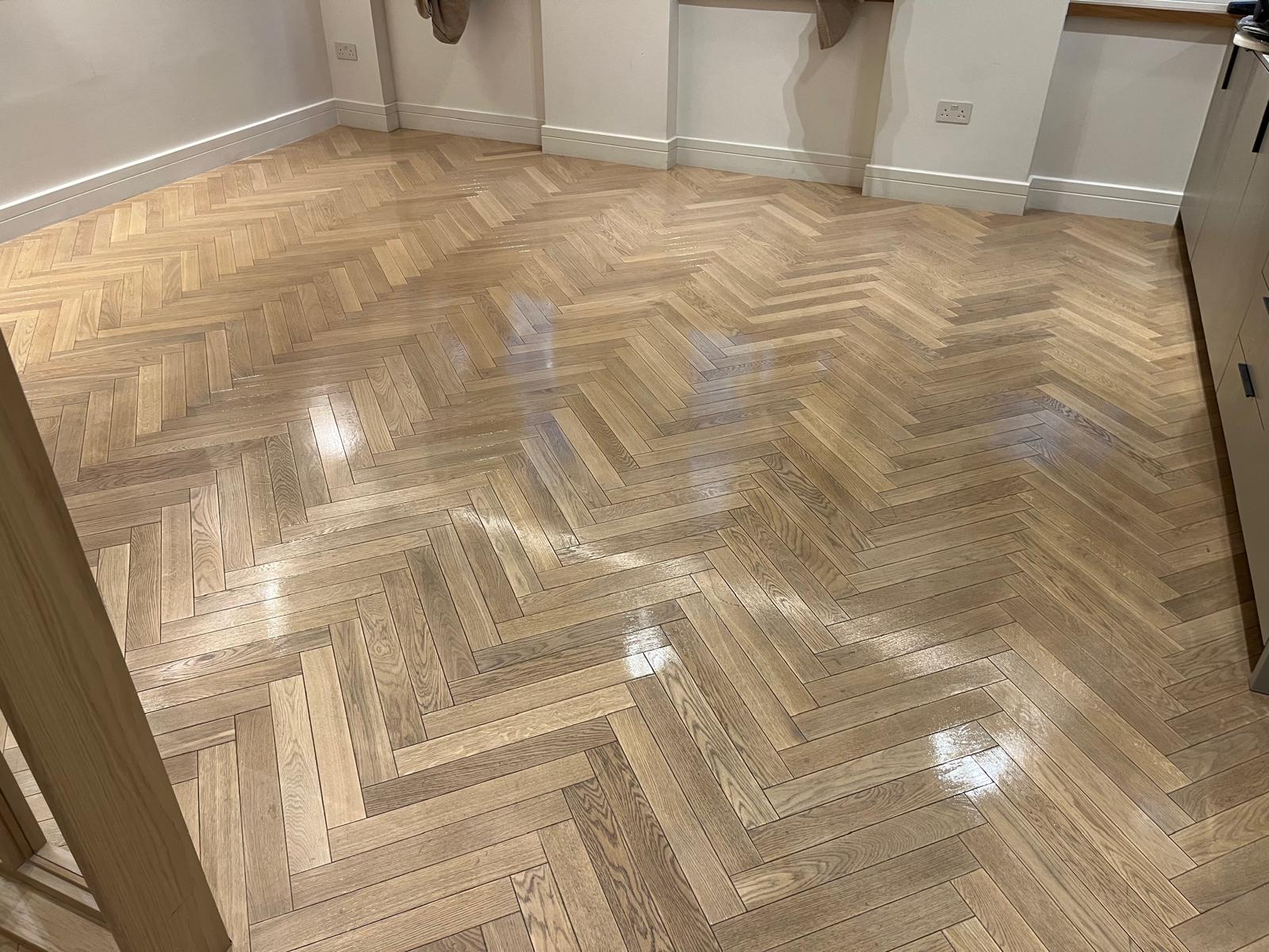 Floor Sanding and Sealing on a finished oak herringbone parquet wood floor with a smooth, even sheen throughout the room.