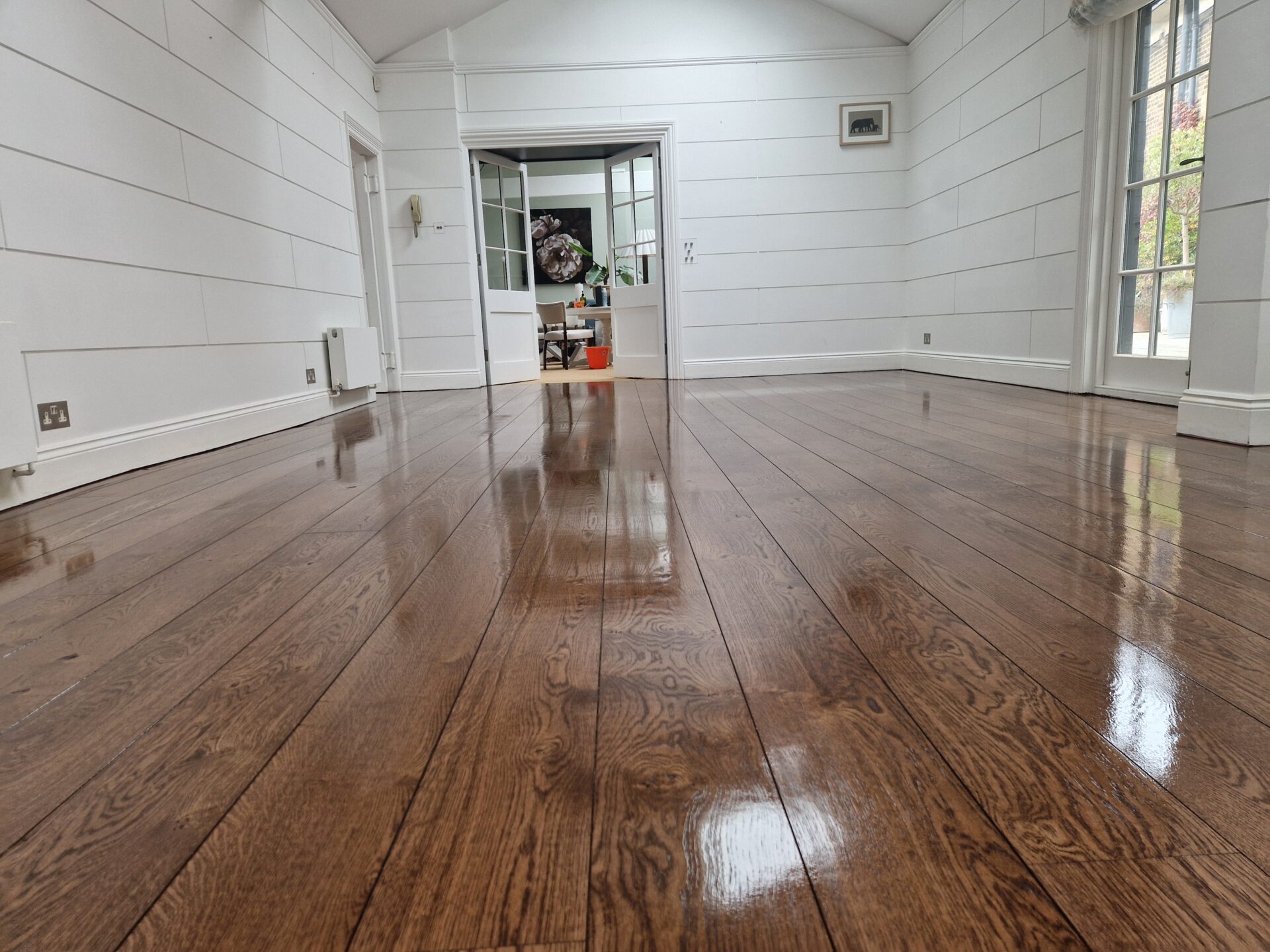 Flawlessly refinished European oak hardwood floor gleaming under natural light, exemplifying Floor Sanding for Eco-Conscientious Homeowners by Mr Sander®.
