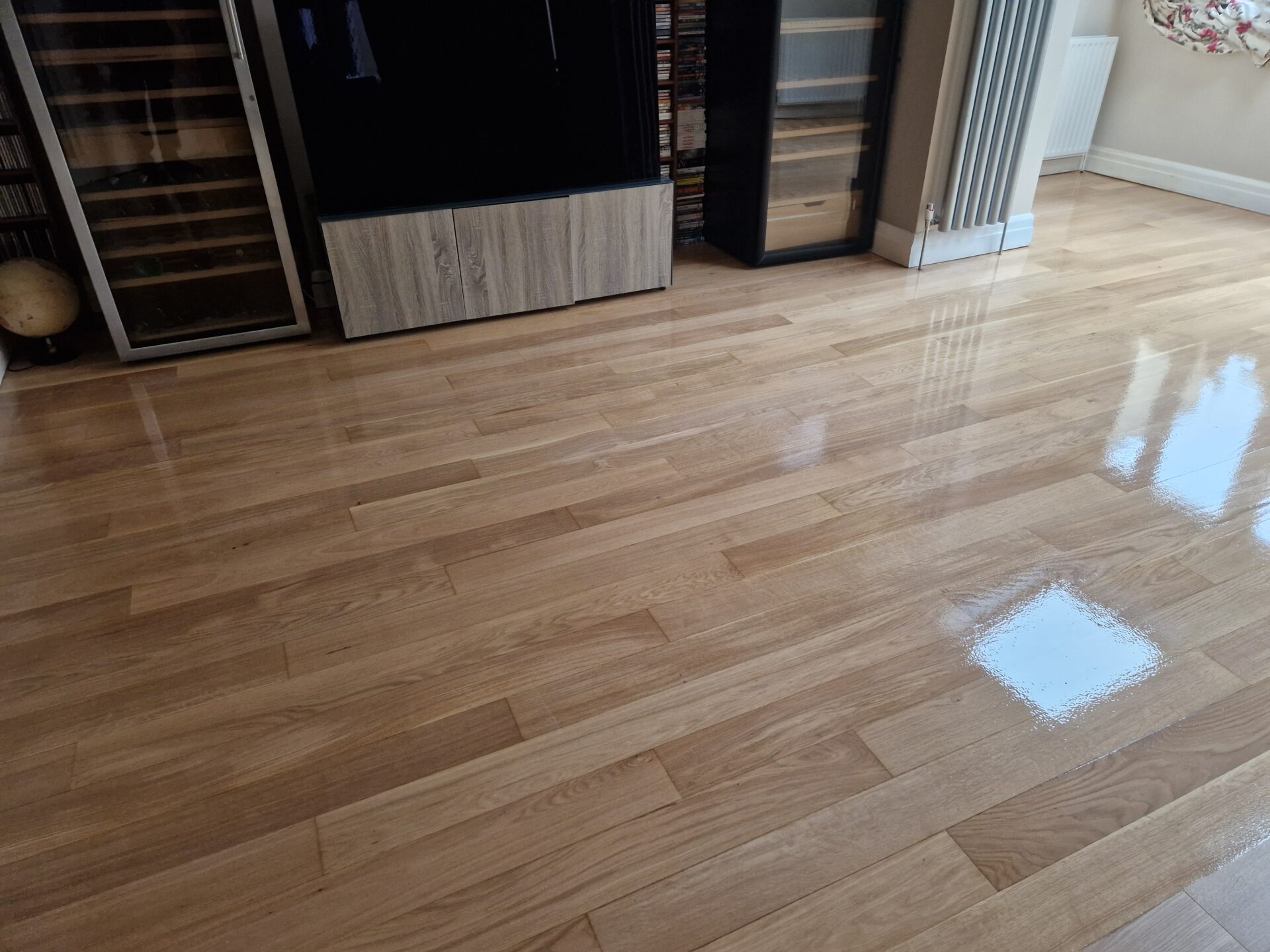 Floor Sanding in London on an engineered oak strip wood floor, fully restored and coated with a high-gloss lacquer for a smooth, reflective finish.