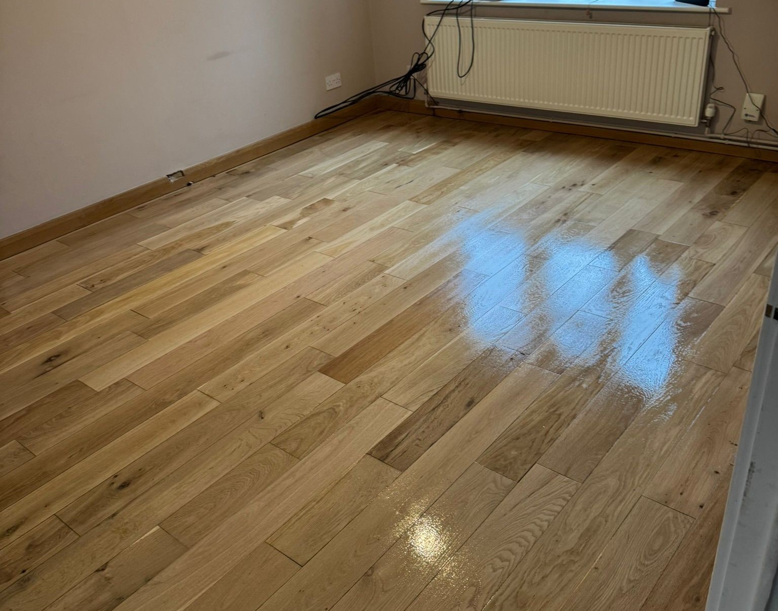 Floor Sanding in London on an oak plank hardwood floor, fully restored with resin gap filling and a fresh lacquer finish for a smooth, glossy surface.
