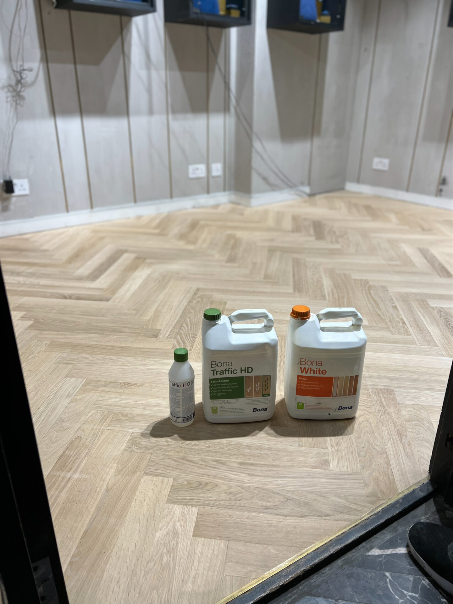 Herringbone oak parquet prepared for Floor Sanding in Retail Spaces with pro-grade finishes staged.