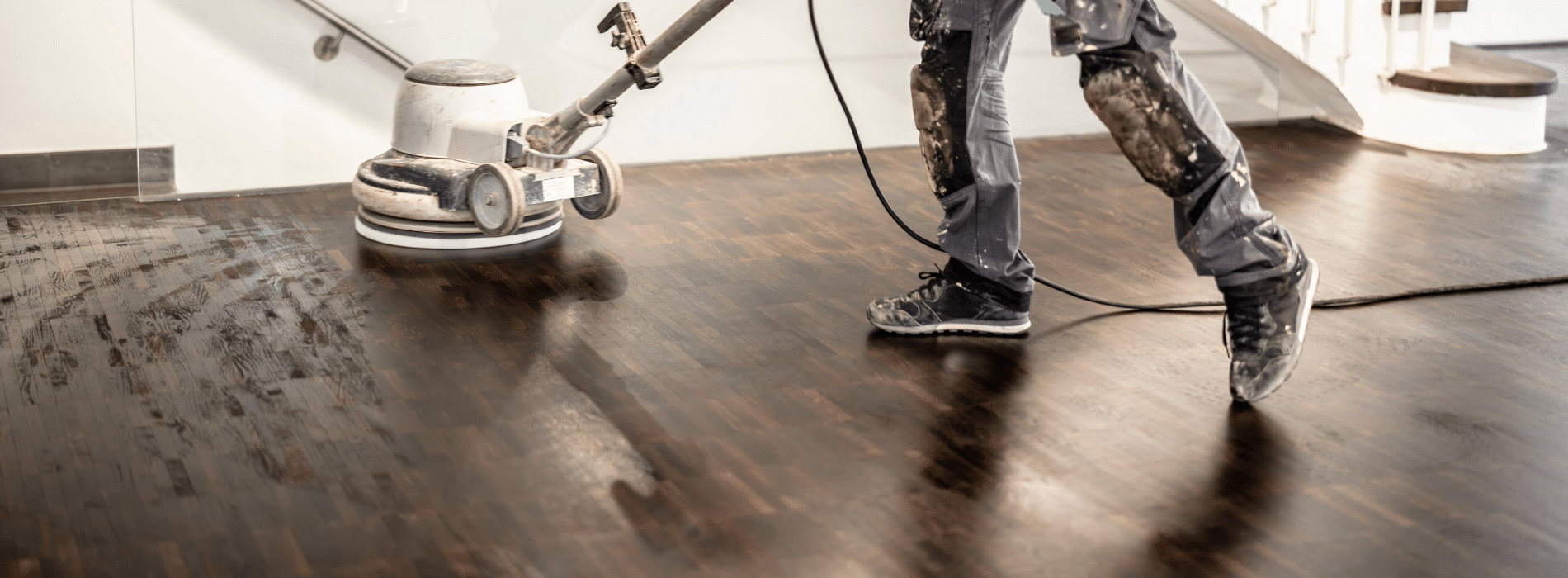 Mr Sander® using a Bona belt sander on a herringbone floor in Hampstead, NW3. The powerful 1950-watt sander is connected to a dust extraction system with a HEPA filter for a clean and efficient sanding process. 