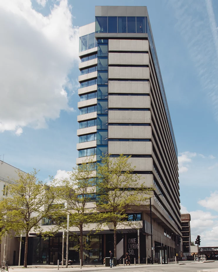 Floor Sanding in High‑Rise Buildings – exterior view of a modern glass‑and‑concrete tower
