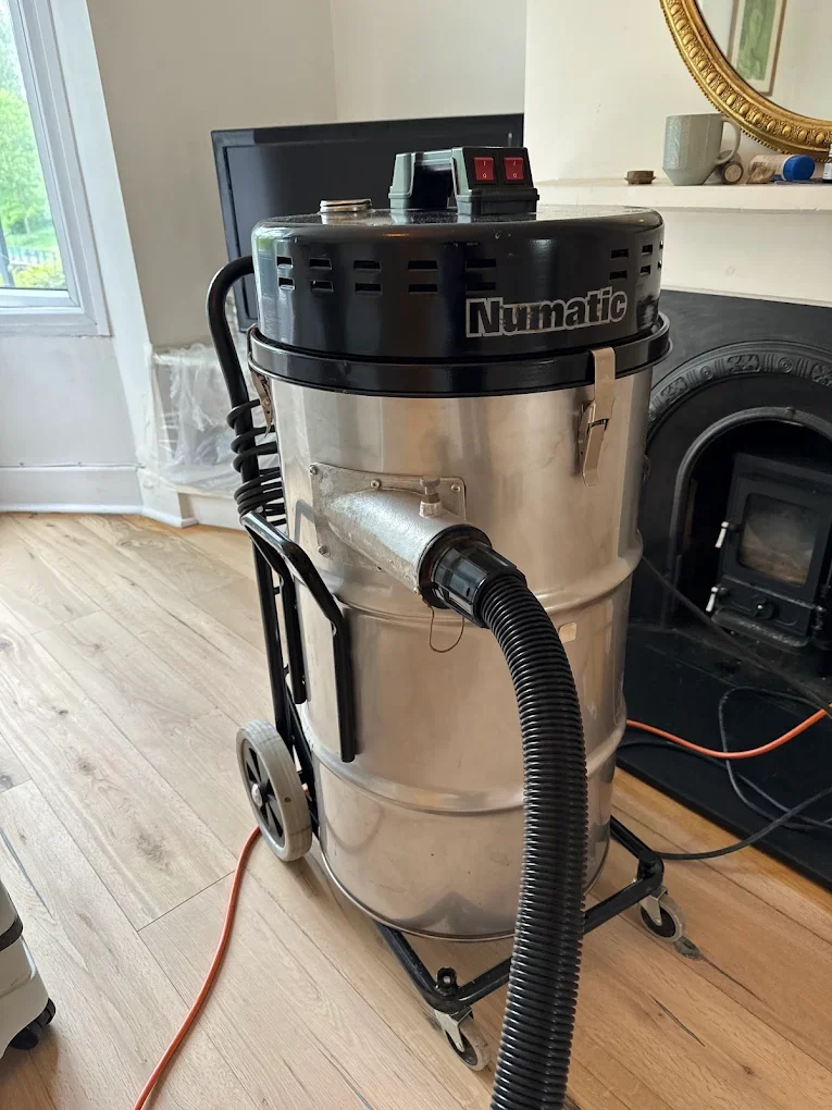 Floor Sanding in High‑Rise Buildings – industrial Numatic dust extractor maintaining clean air during hardwood refurbishment