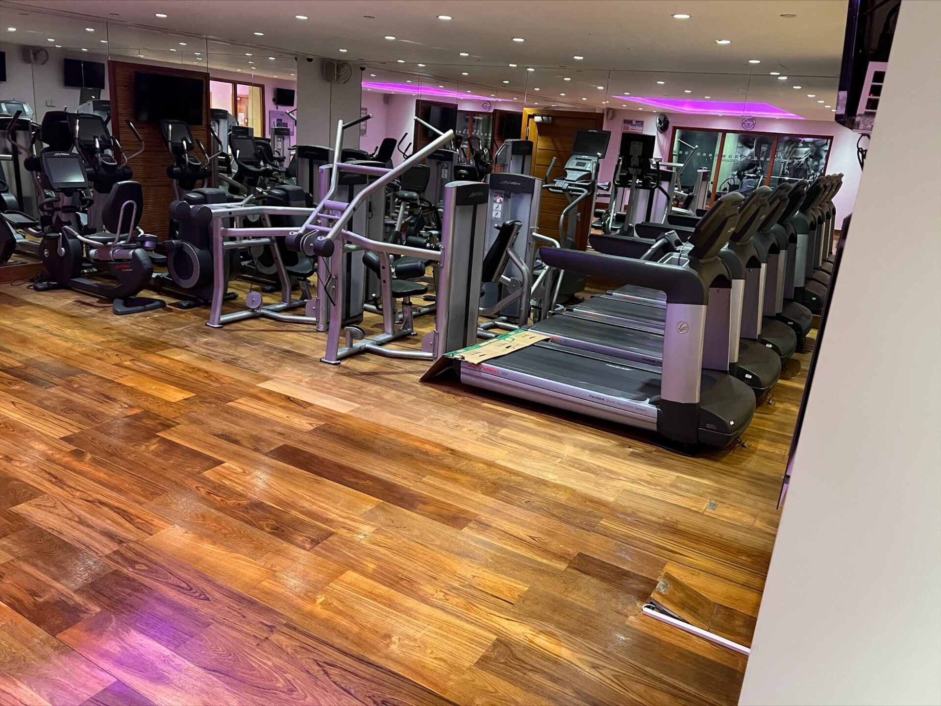 Walnut strip floor in a gym awaiting Floor Sanding and Water-Based Finishes by Mr Sander®