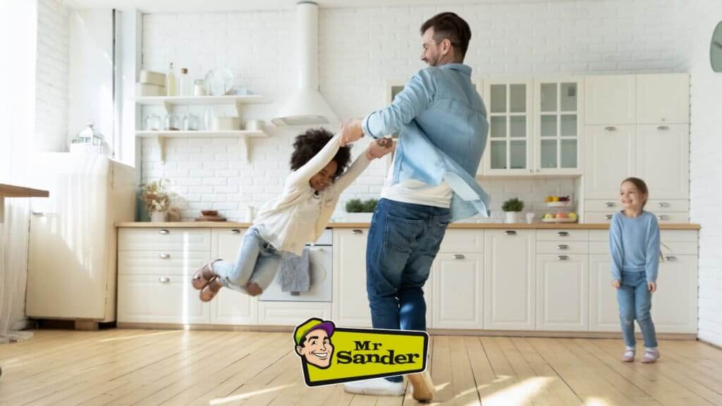 a man and a child dancing in a kitchen