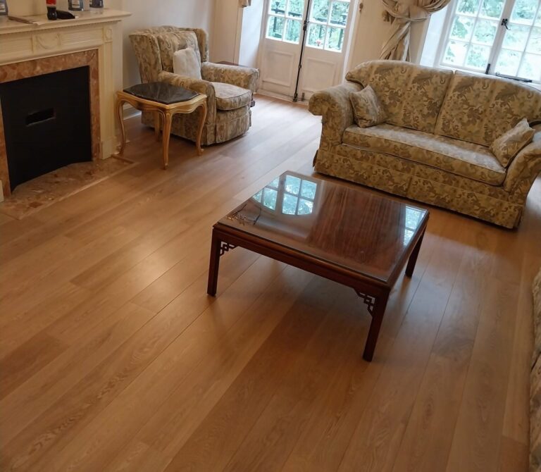 Junckers vs Kährs comparison showing a European Oak engineered wood floor with a low-sheen finish in a classic living room, highlighting wide planks and refined grain.