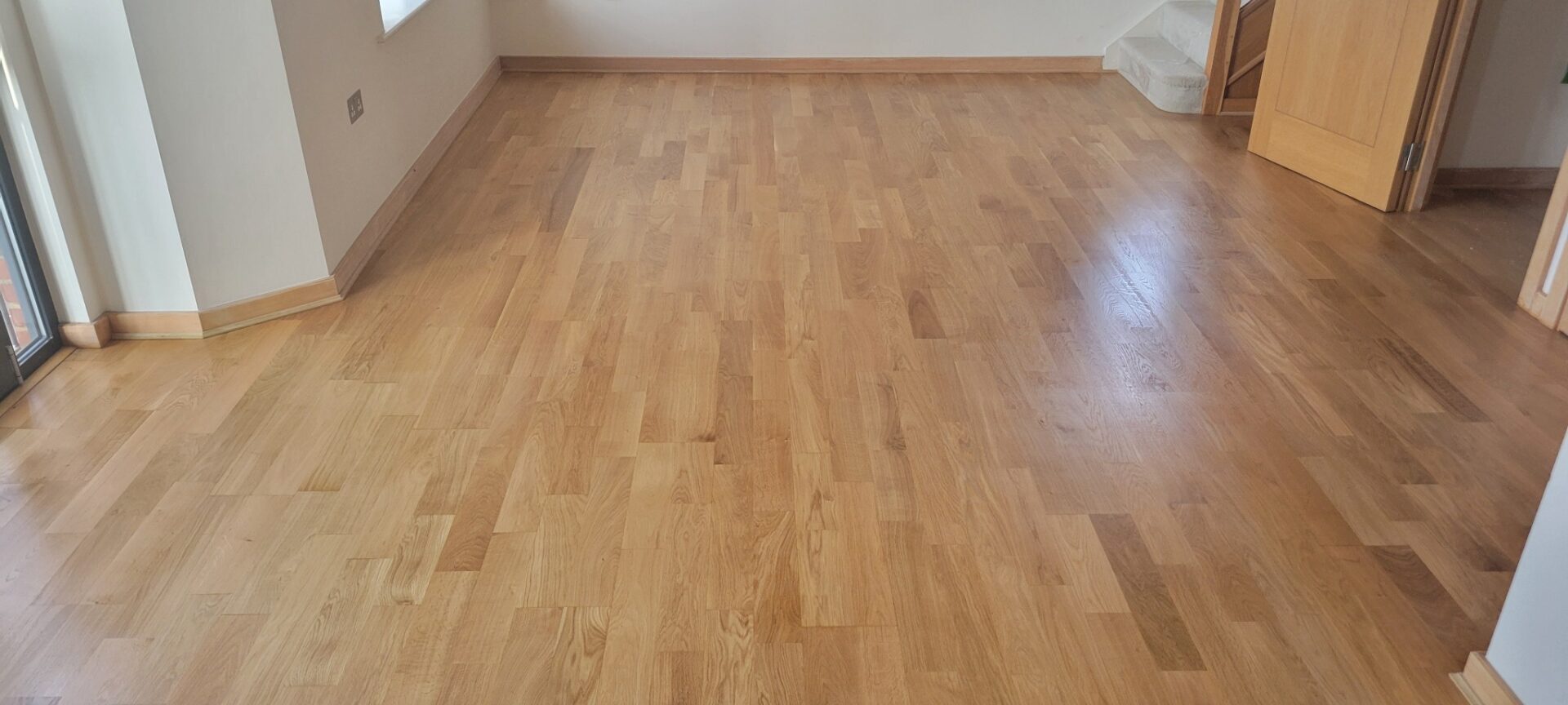 Sun-lit living room with oak strip floor after Floor Sanding and Water-Based Finishes by Mr Sander®