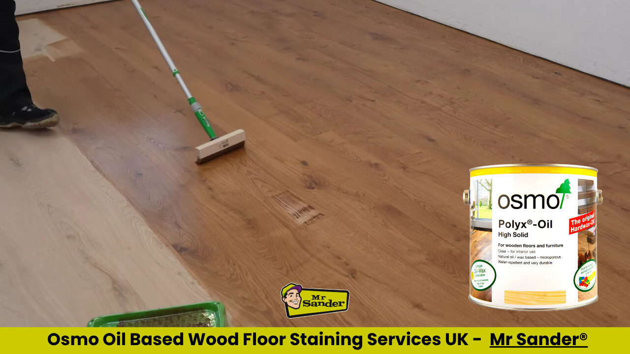 Flooring professional applying Osmo Polyx‑Oil to freshly sanded oak boards, revealing a richer mid‑brown tone.