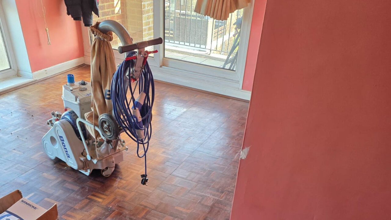 Bona sanding machine set up on a worn oak parquet block wood floor during Professional Sanding, preparing the timber surface for full restoration.