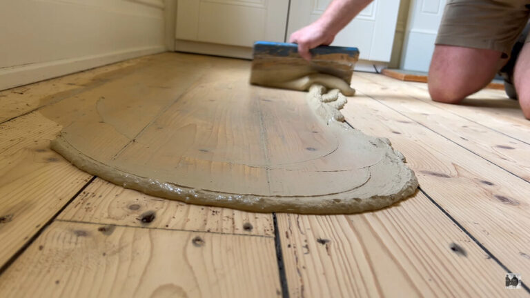Resin Fill applied across sanded solid pine floorboards (softwood), closing gaps during professional wood-floor restoration.