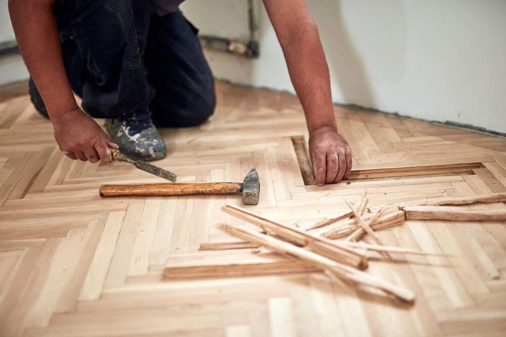 Restoring Hidden Parquet Floors—replacing loose herringbone blocks with chisel and mallet.