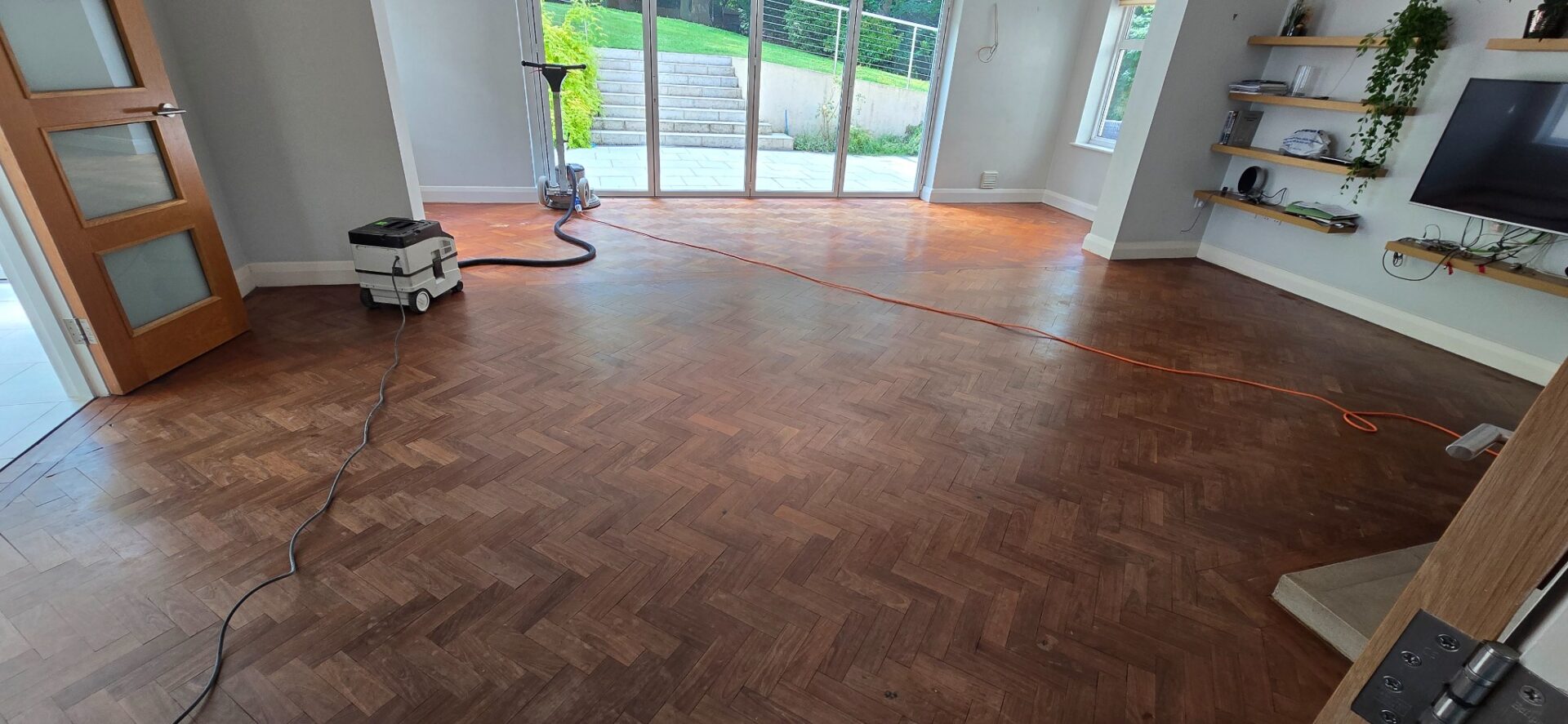 Restoring Hidden Parquet Floors—living room herringbone parquet prepped with buffer and dust extractor.