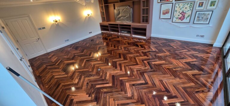 Revitalizing Your Parquet Flooring: herringbone parquet restored and finished to a deep, high-gloss sheen in a modern living room