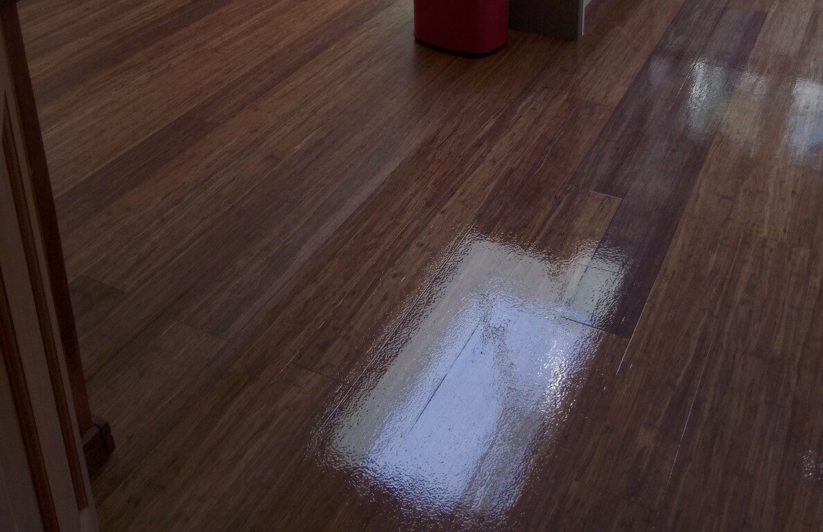 Sand and Seal on bamboo wood floor (strand-woven engineered), freshly refinished in an open-plan kitchen–diner with a smooth, high-sheen protective coat.