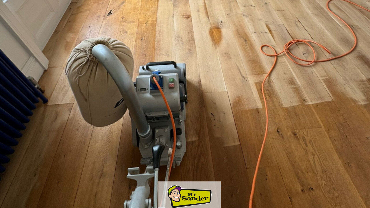 Professional drum sander in use while sanding hardwood floors in a UK home