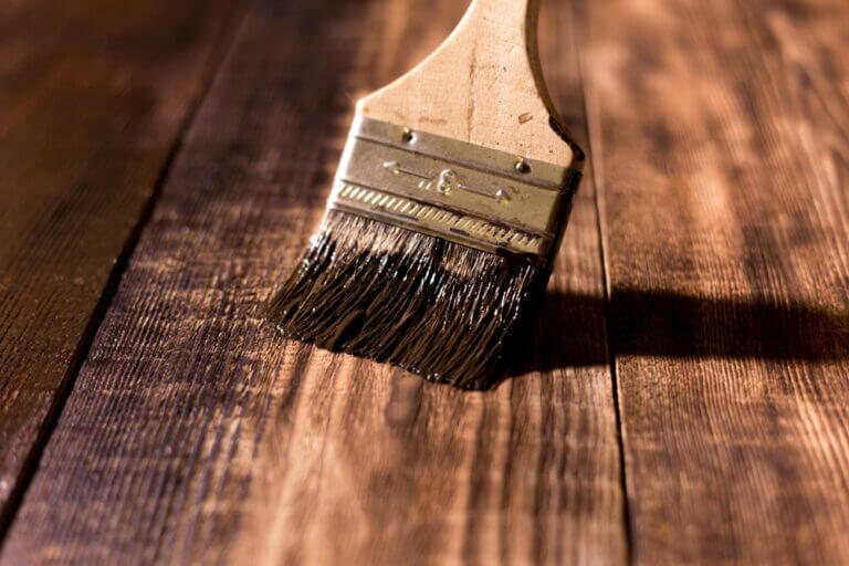 Male,Hand,Paint,Wooden,Surface,With,Brown,Paint,Using,A