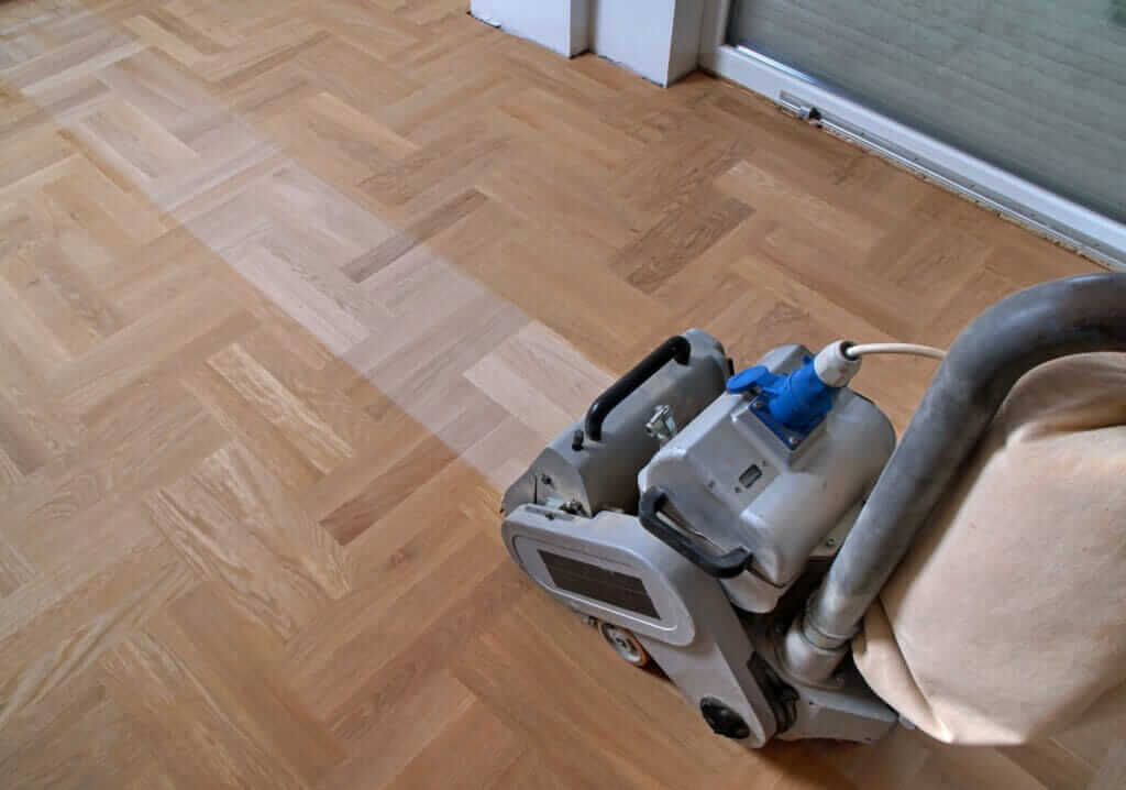 Mr Sander® Professional Bona Belt sander (AMO110000.3) with 2.2 kW motor power, 230 V voltage, sanding a parquet floor in a living area in Dalston, UK. Drum width options: 200 & 250 mm, total weight 74 kg, belt size: 200 x 750 mm or 250 x 750 mm