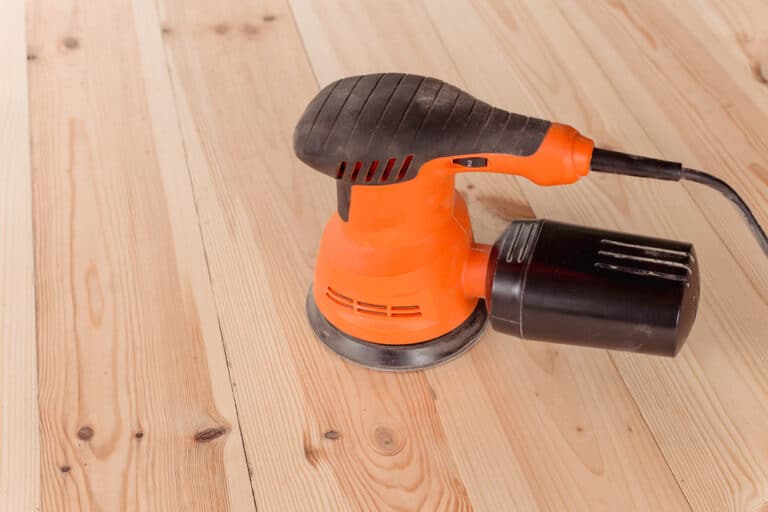 Side,View,Of,The,Orbital,Sander,On,A,Wooden,Table