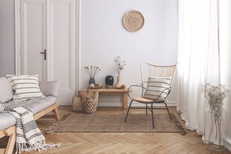 Armchair,On,Rug,Next,To,Bench,With,Plants,In,White