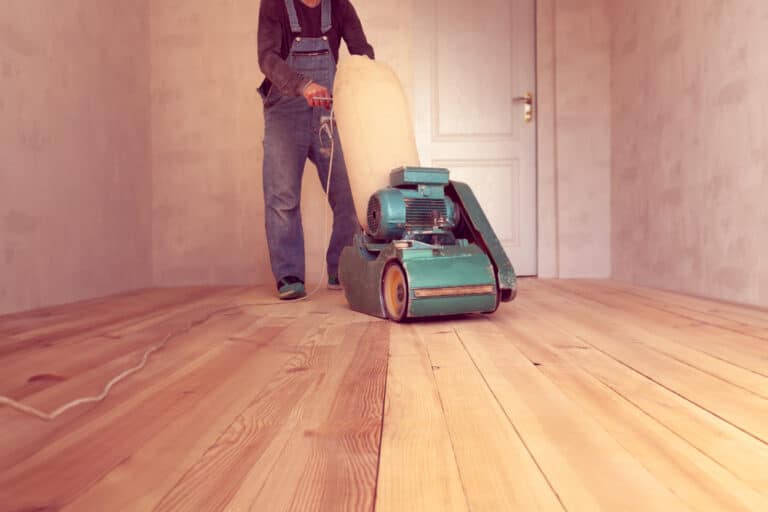 Carpenter,Polishes,A,Wooden,Floor,By,Electric,Grinding,Wood,Machine
