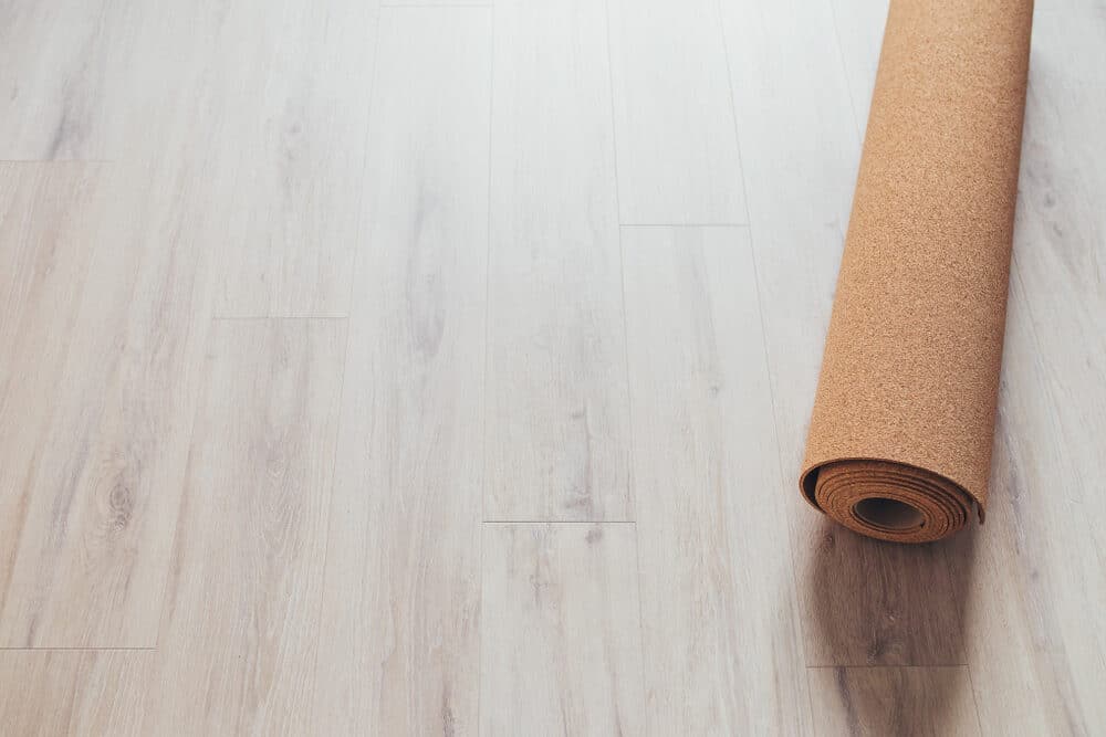 Rolled cork underlayment on a laminate wood floor.