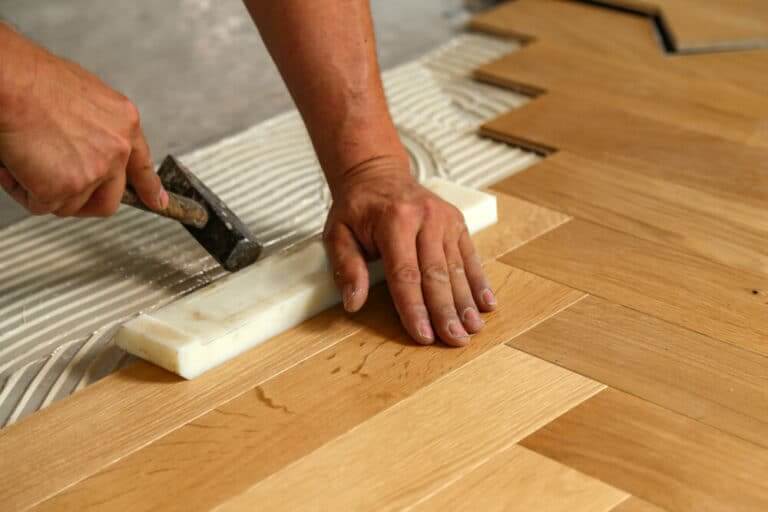 Worker,Laying,Parquet,Flooring.,Worker,Installing,Wooden,Laminate,Flooring