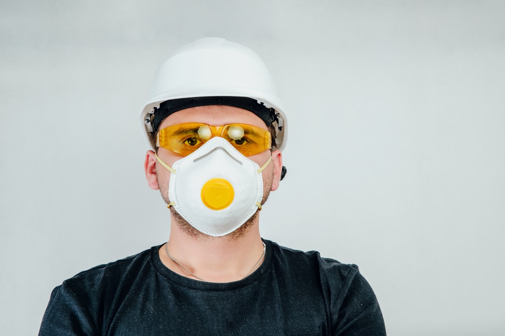 Construction worker with safety helmet and protective mask