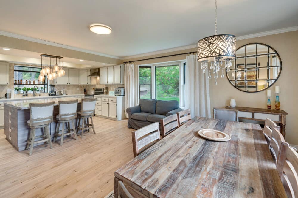 Open-concept kitchen and dining area with elegant light wood flooring and cozy furnishings.
