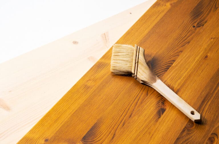 Oil,Stained,Wood,Boards,And,Brushes.,Picture,Of,The,Painting