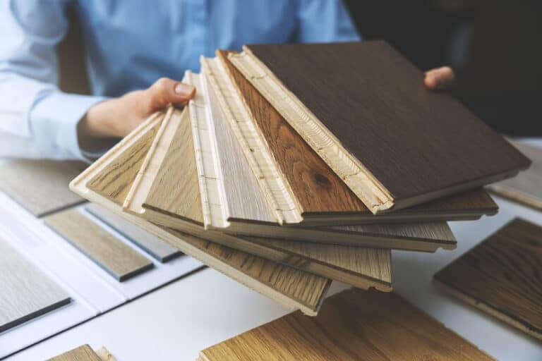 Parquet,Floor,-,Store,Salesman,With,Flooring,Samples,In,Hands