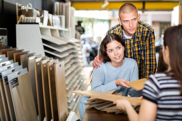 Competent,Seller,Consulting,Young,Couple,About,Purchase,Of,Laminate,Flooring