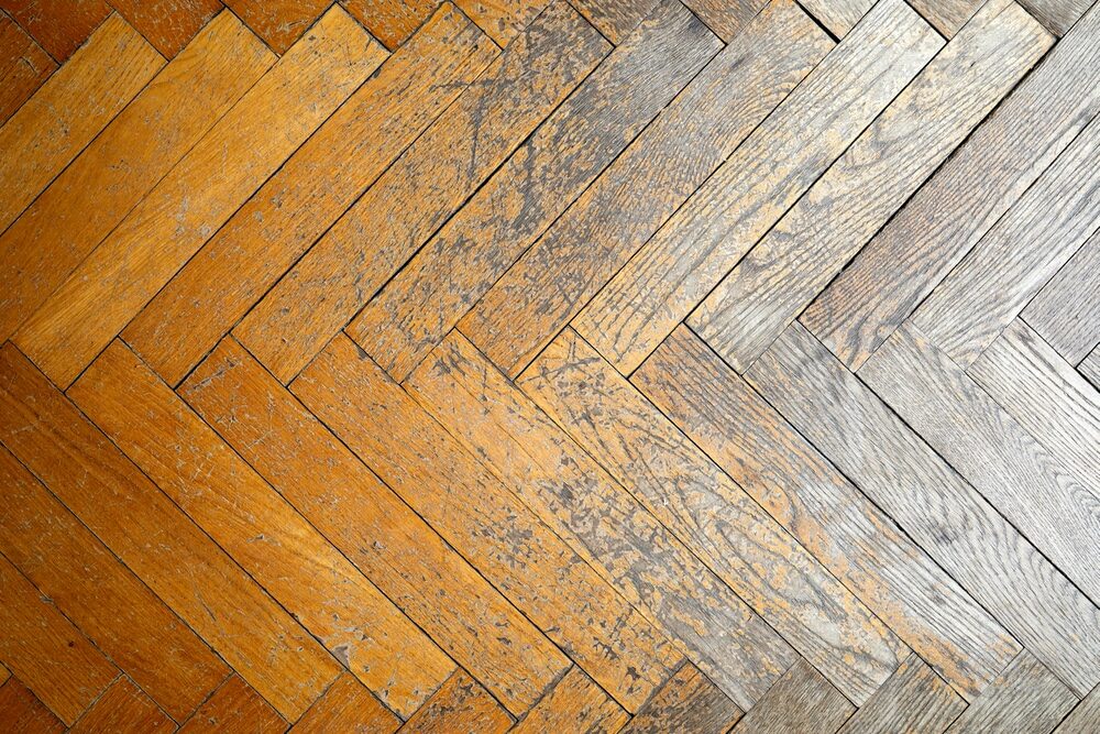 Very worn solid hardwood parquet flooring. 