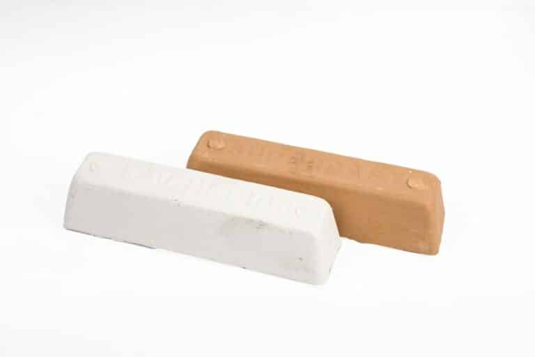 Two bars of tailor's chalk in white and beige on a white background.
