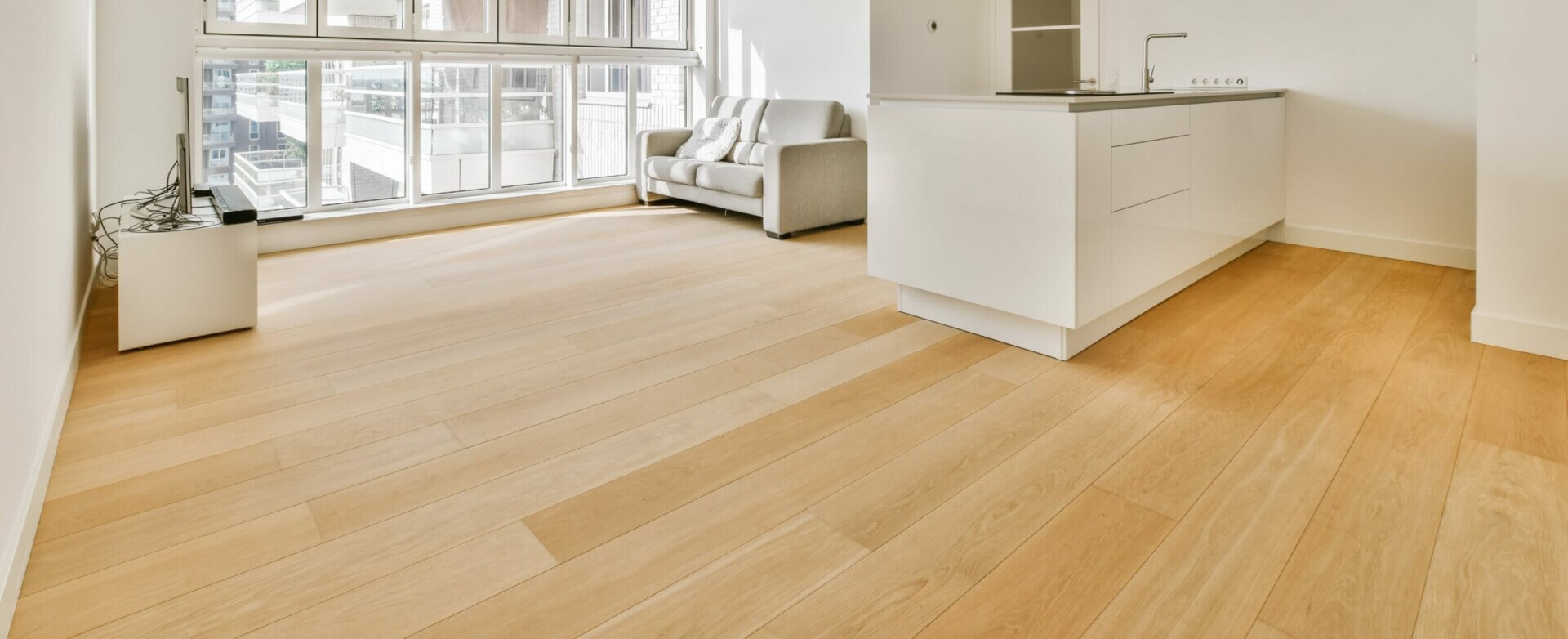 Kährs Floor Fitting in a modern living room and kitchen. The floor fitting and refinishing were done by Mr Sander®. The flooring is 15 mm thick and provides a smooth, elegant finish to the interior.
