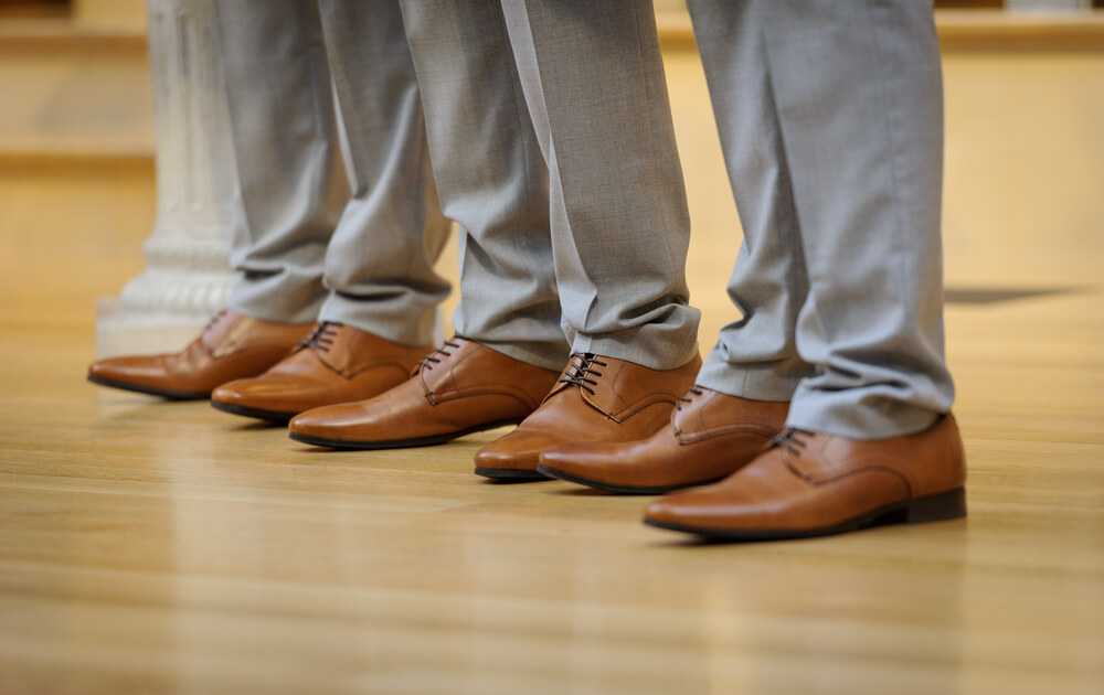 a row of men's shoes on freshly sanded Church flooring