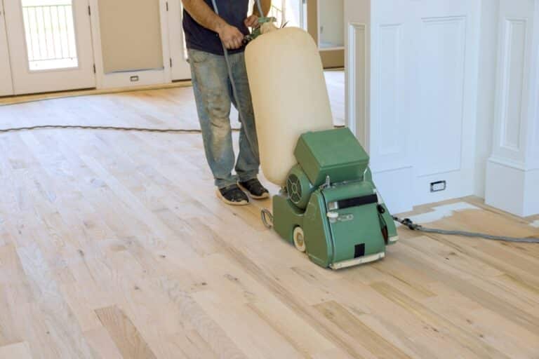 Carpenter,Grinding,Wooden,Parquet,Floor,By,Using,Floor,Sander,An