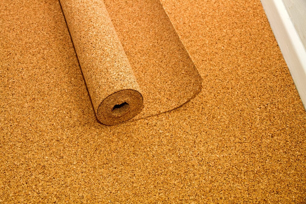 Close-up of a cork underlayment roll on a floor.