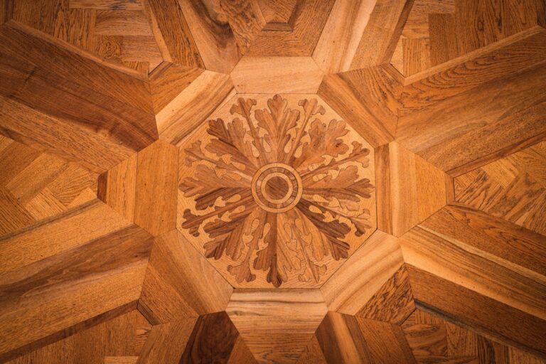 Detailed wood floor inlay design with geometric patterns and a central floral motif.