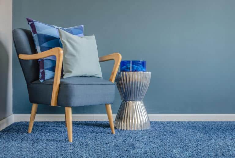 Wooden,Chair,With,Blue,Color,Pillow,On,Carpet,In,Living