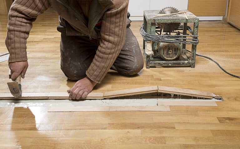 Manual,Worker,Fixing,Wooden,Floor,Ruined,From,Moisture,And,Water