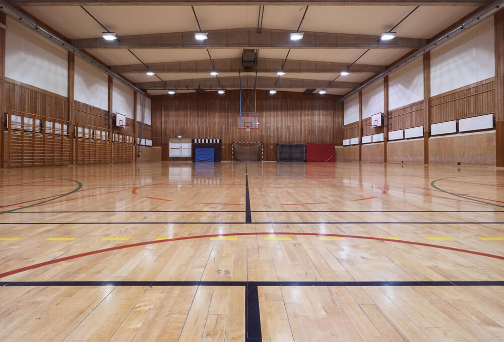 a gym with a basketball hoop and a basketball court