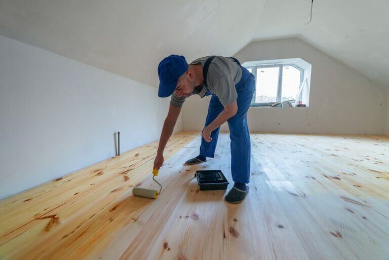 Wooden,Floor,Varnished.,Worker,With,Paint,Roller.